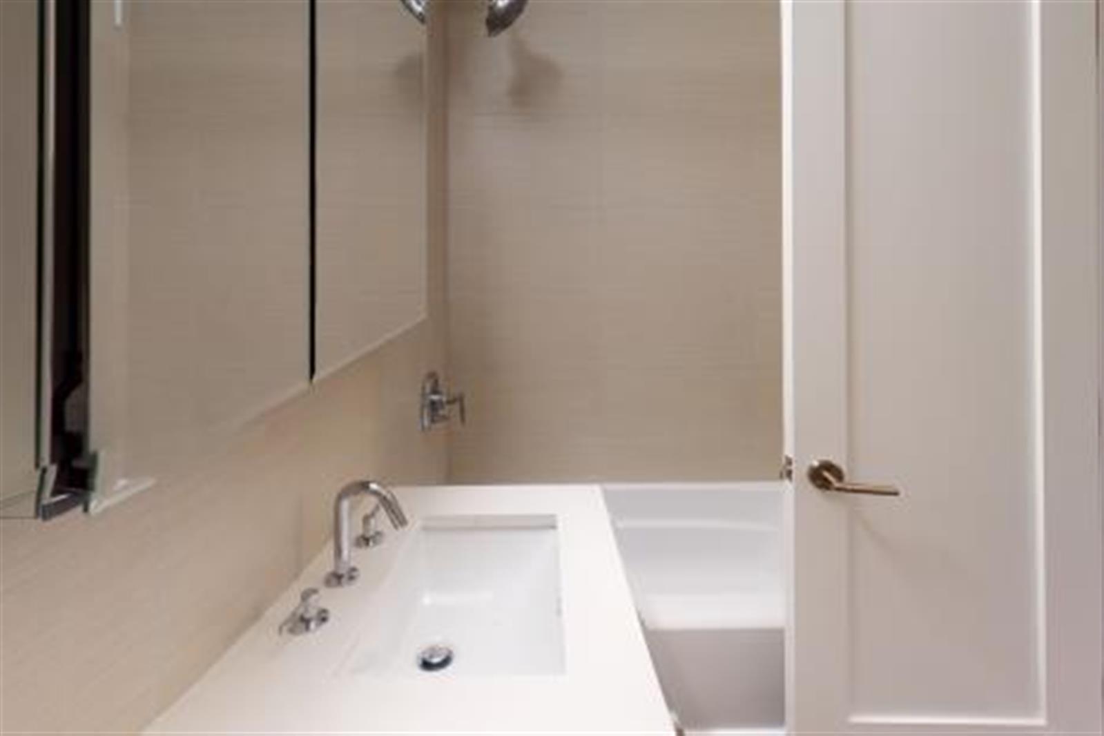 40 Harrison Street, Unit 4K Manhattan, NY 10013 - Photo 1 of 1 a bathroom with a sink