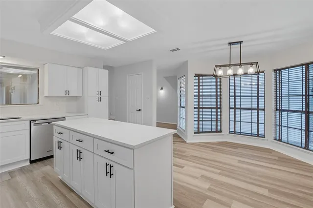a kitchen with white cabinets and white appliances