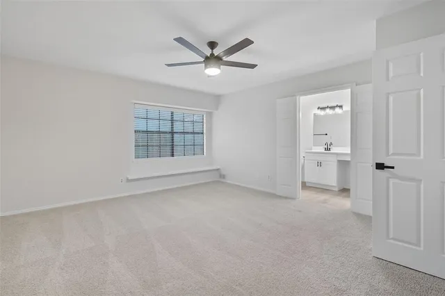 a bathroom with a sink a toilet and a large mirror