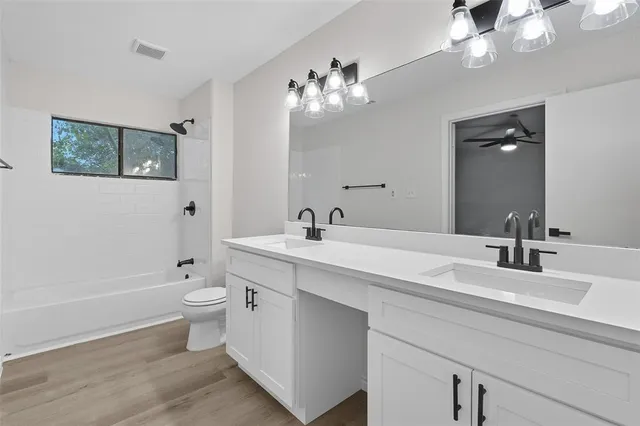 a bathroom with a double vanity sink and a mirror