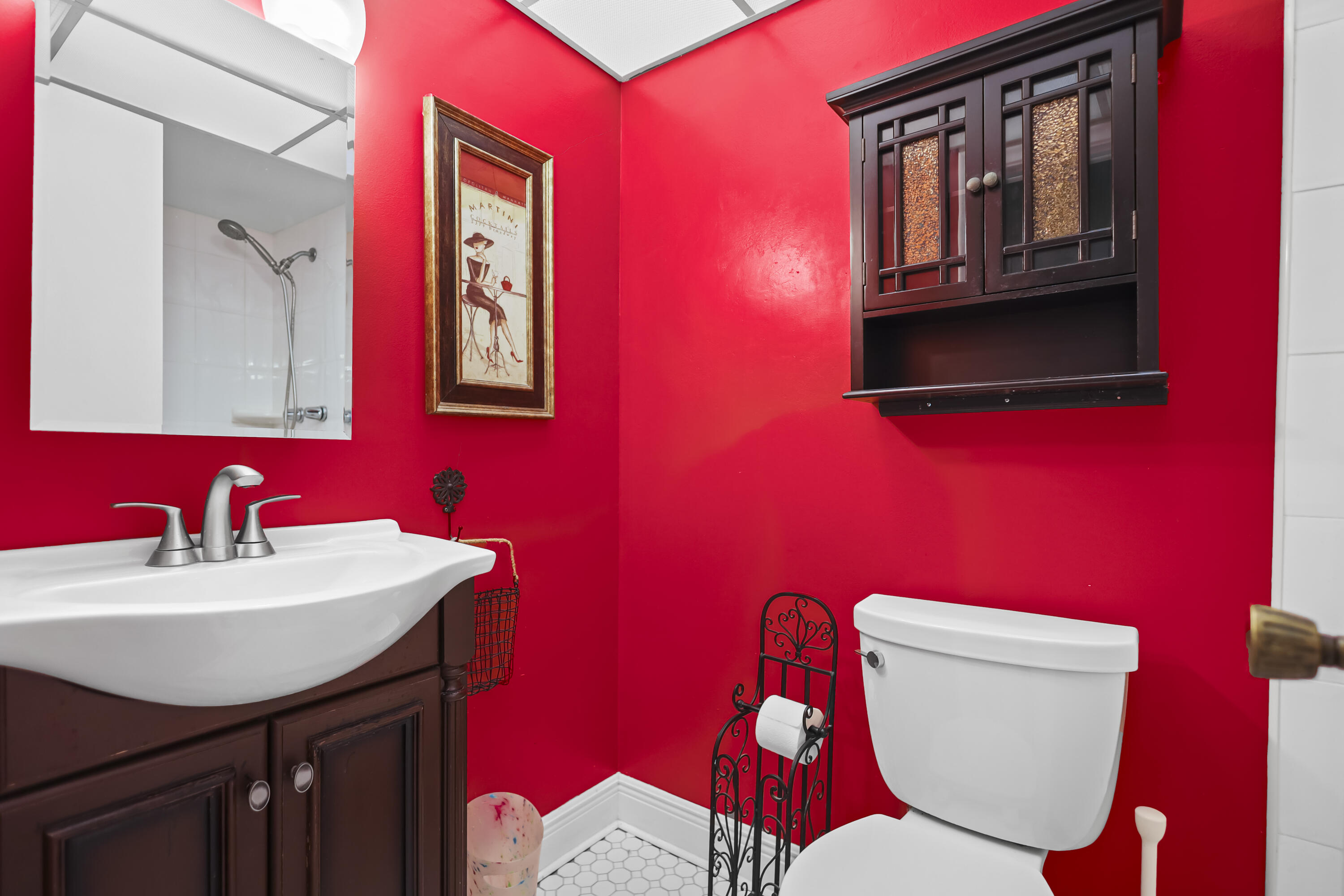 2500 Fiore Way, Unit 103 Delray Beach, FL 33445 - Photo 11 of 19 a bathroom with a toilet a sink and mirror