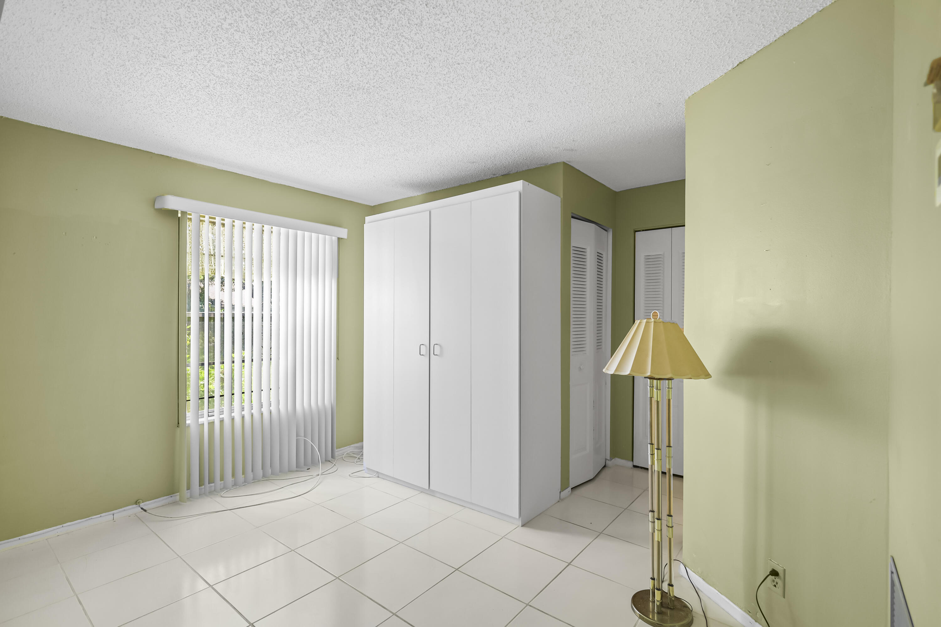 2500 Fiore Way, Unit 103 Delray Beach, FL 33445 - Photo 12 of 19 a view of a room with entryway and wooden floor
