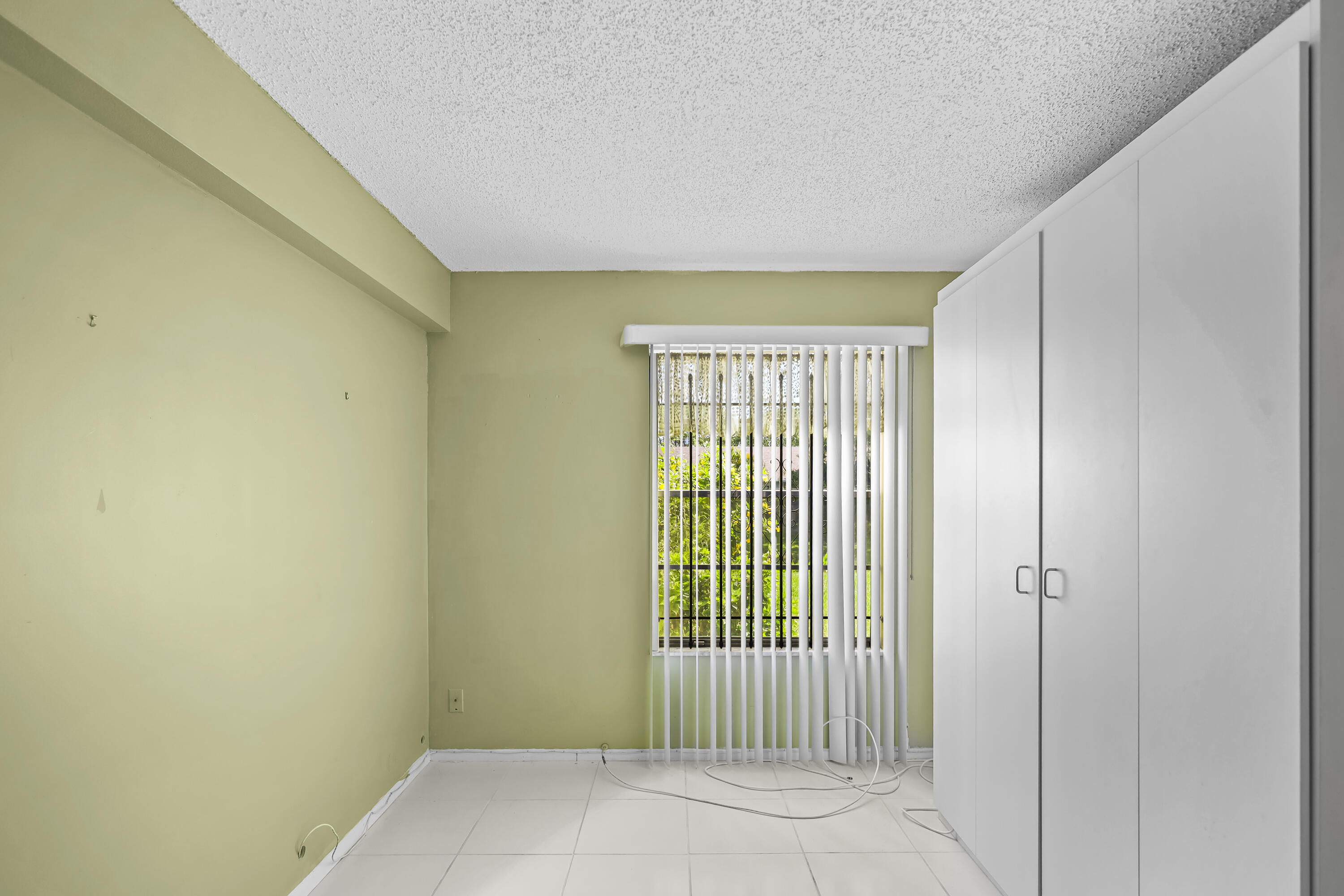 2500 Fiore Way, Unit 103 Delray Beach, FL 33445 - Photo 15 of 19 a view of an empty room with a window