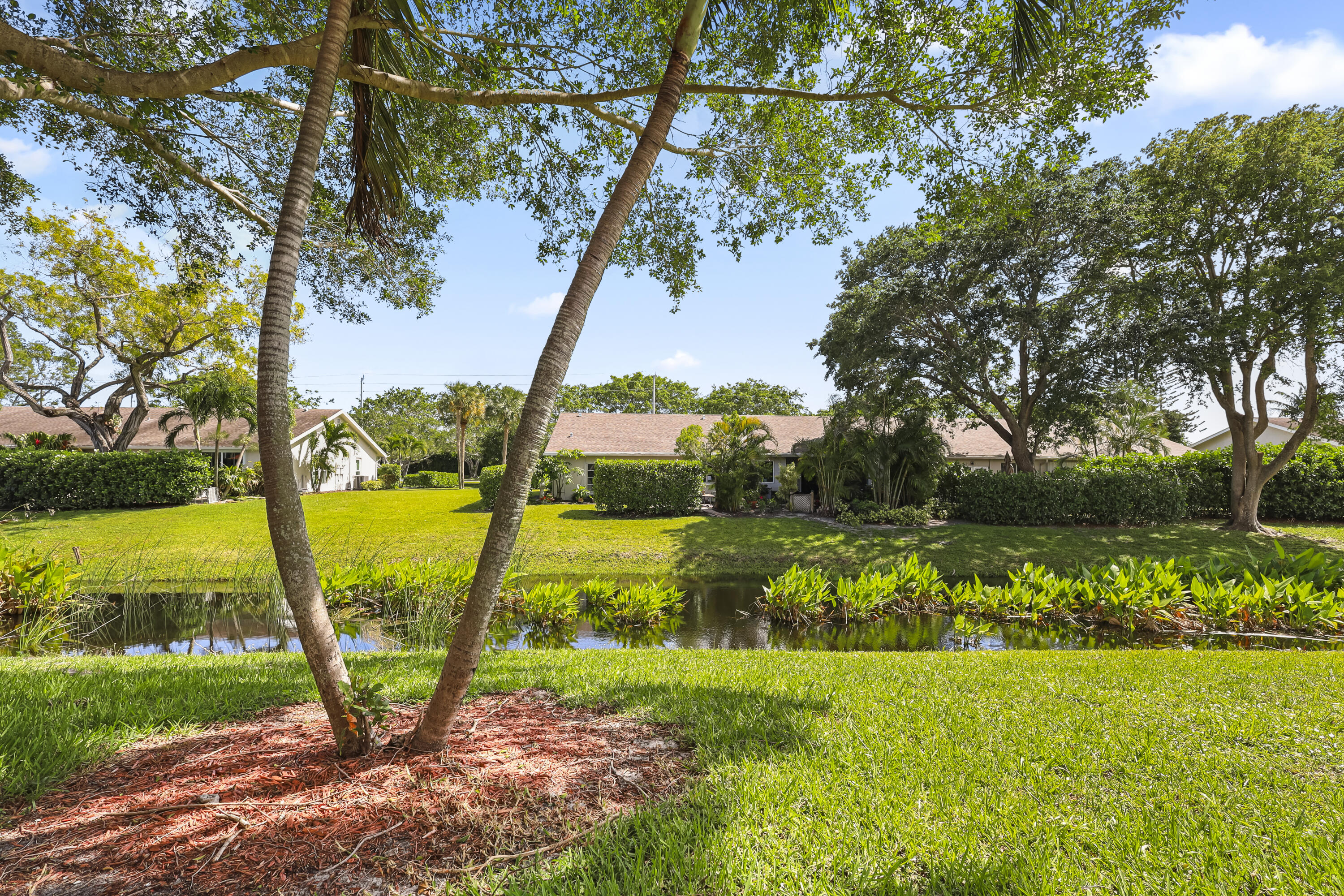 2500 Fiore Way, Unit 103 Delray Beach, FL 33445 - Photo 18 of 19 a view of a yard with an outdoor space