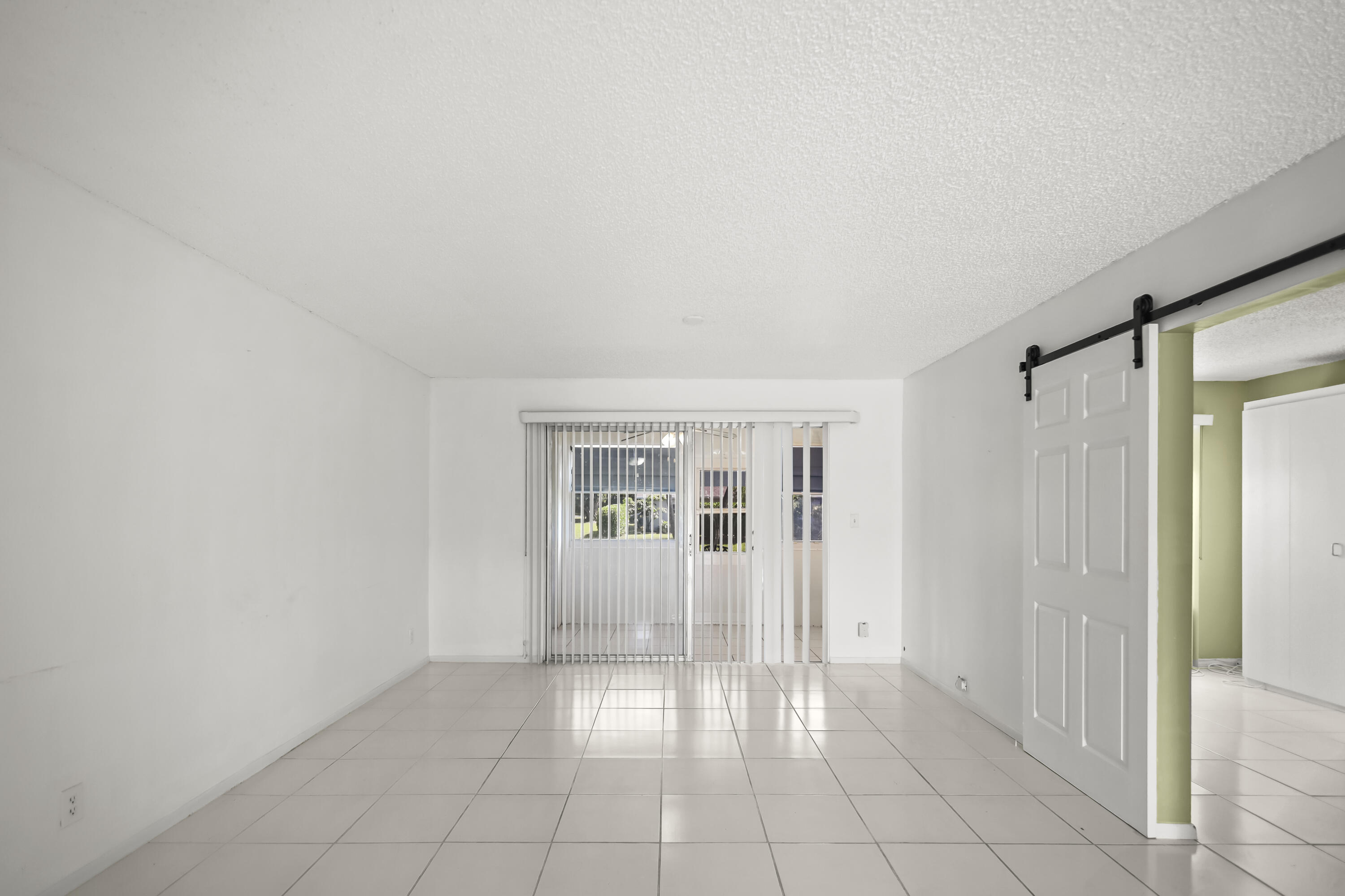 2500 Fiore Way, Unit 103 Delray Beach, FL 33445 - Photo 2 of 19 a view of an empty room and window