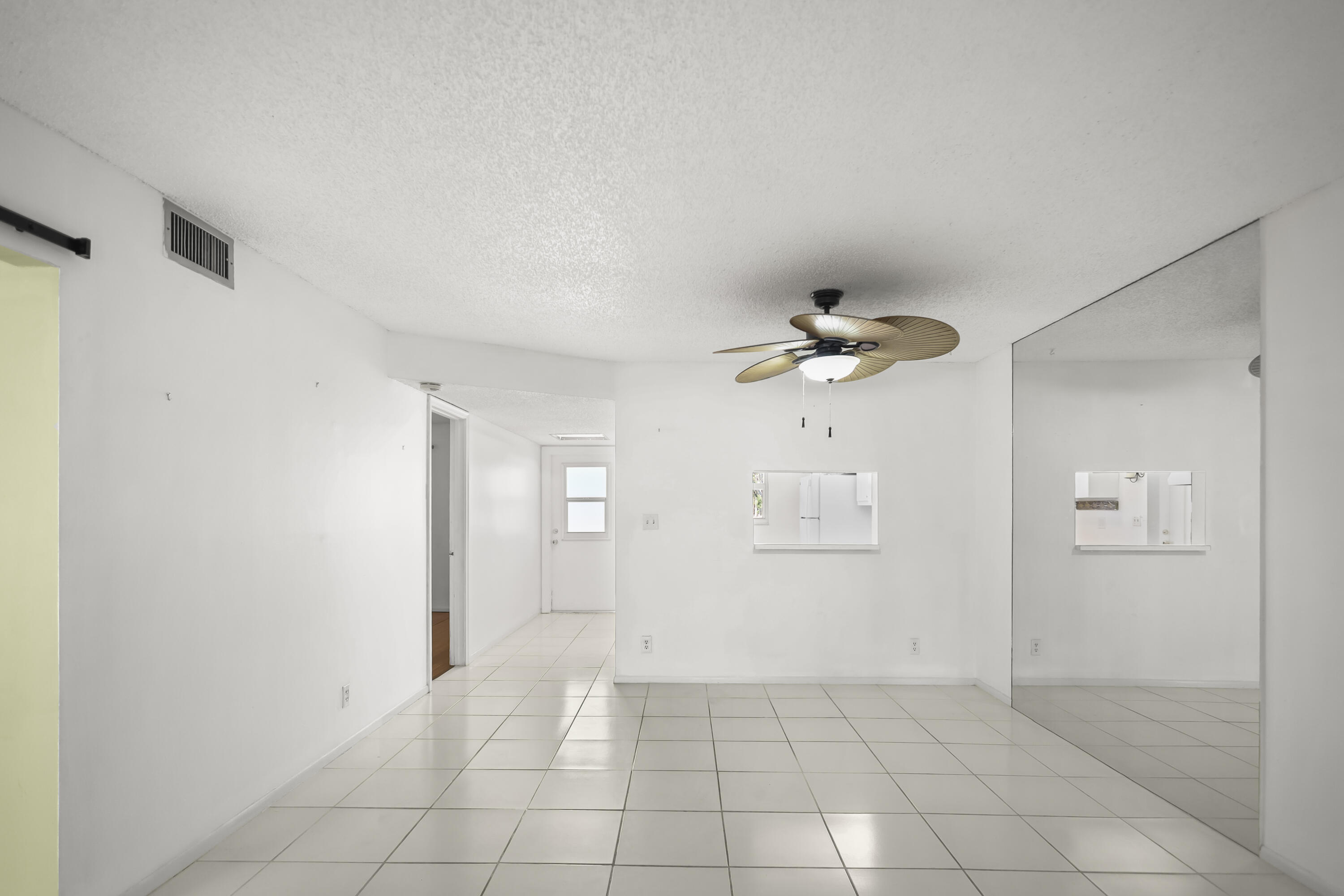 2500 Fiore Way, Unit 103 Delray Beach, FL 33445 - Photo 3 of 19 wooden floor in an empty room with a window