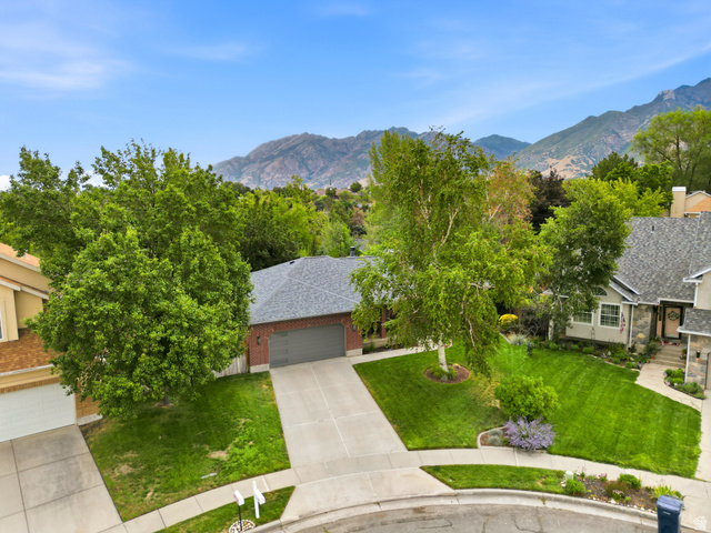 2073 Village Point Way Sandy, UT 84093 - Photo 65 of 68 Brick exterior home with an attached garage, newer shingle roof, and a paved driveway