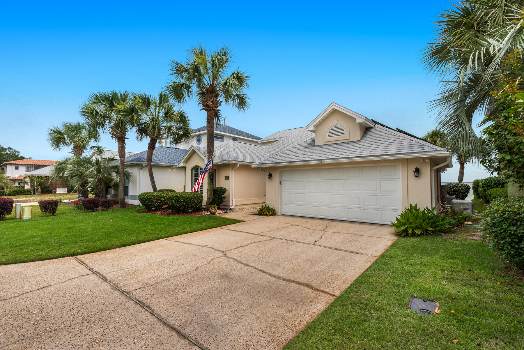 311 Country Club Road Shalimar, FL 32579 - Photo 18 of 73 a front view of a house with a yard and garage