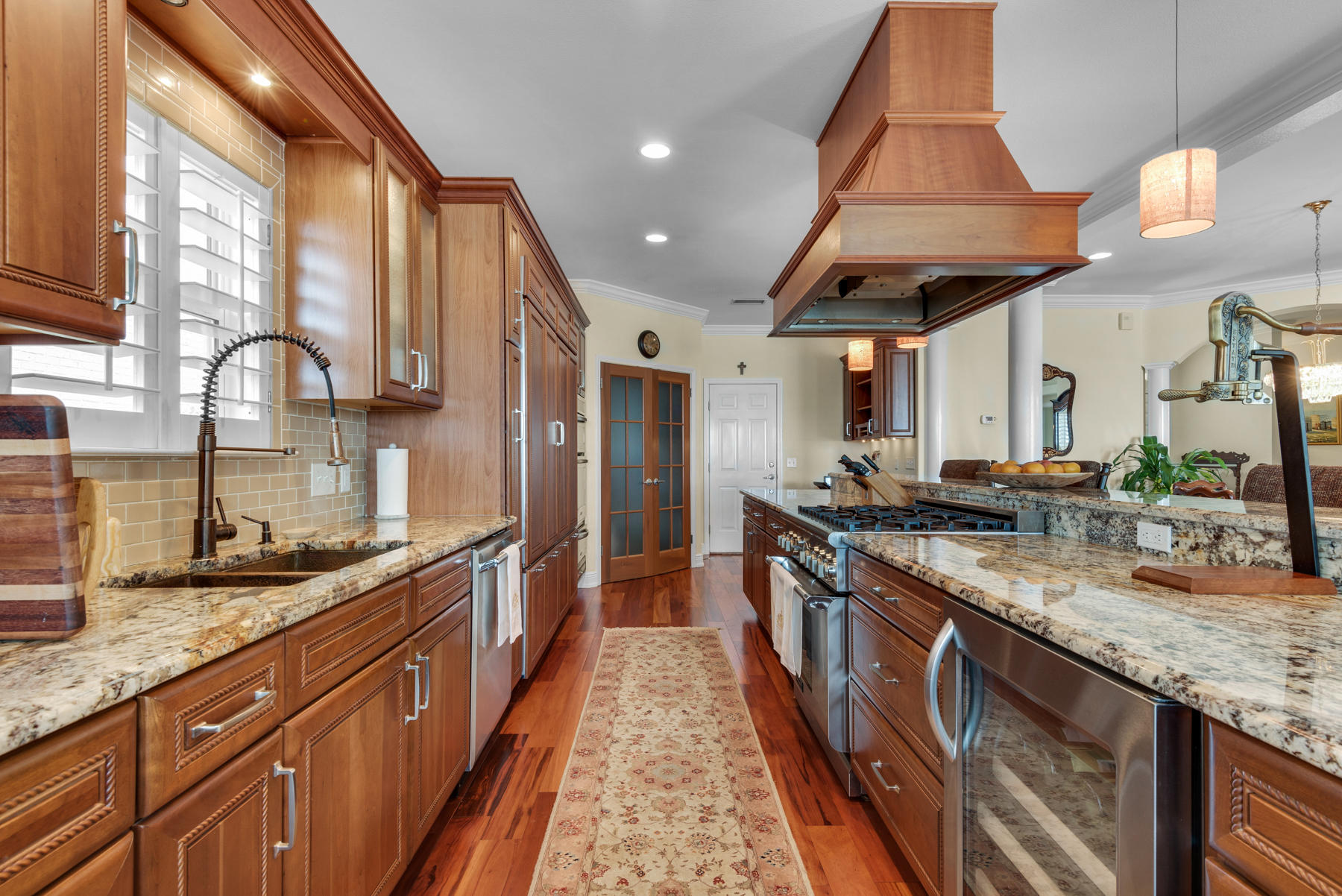 311 Country Club Road Shalimar, FL 32579 - Photo 32 of 73 a large kitchen with stainless steel appliances granite countertop a large stove a sink and a wooden cabinets