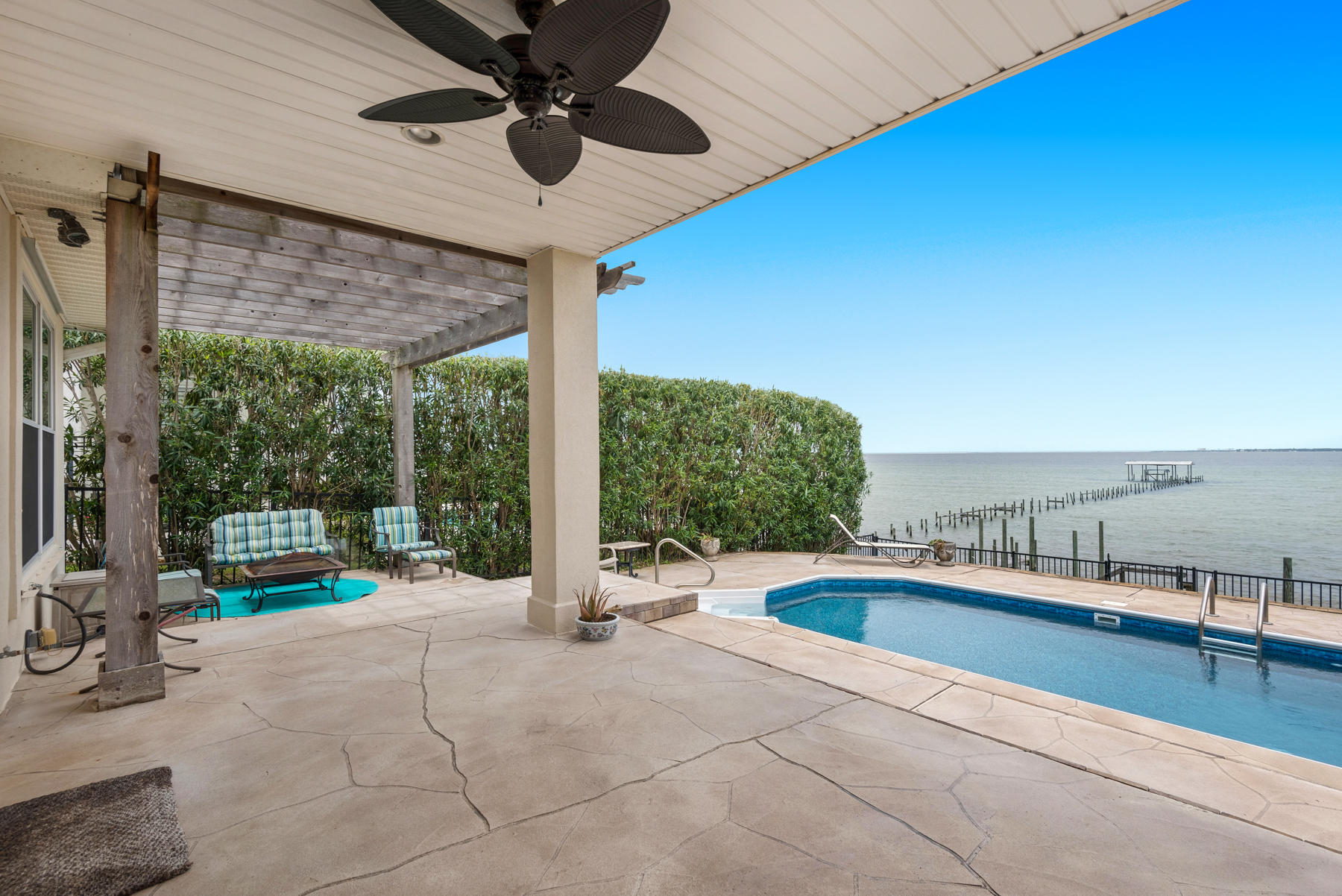 311 Country Club Road Shalimar, FL 32579 - Photo 57 of 73 a swimming pool with lawn chairs and iron fence