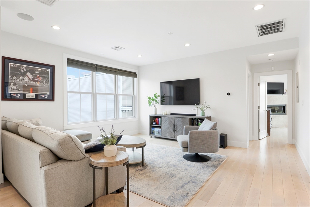 309 E Street, Unit 45 Boston, MA 02127 - Photo 1 of 33 a living room with furniture and a flat screen tv