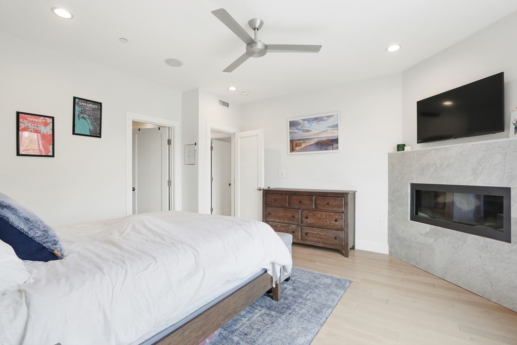309 E Street, Unit 45 Boston, MA 02127 - Photo 11 of 33 a spacious bedroom with a bed and a flat screen tv