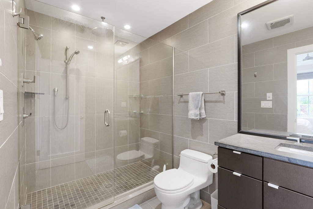 309 E Street, Unit 45 Boston, MA 02127 - Photo 14 of 33 a bathroom with a sink a toilet and shower