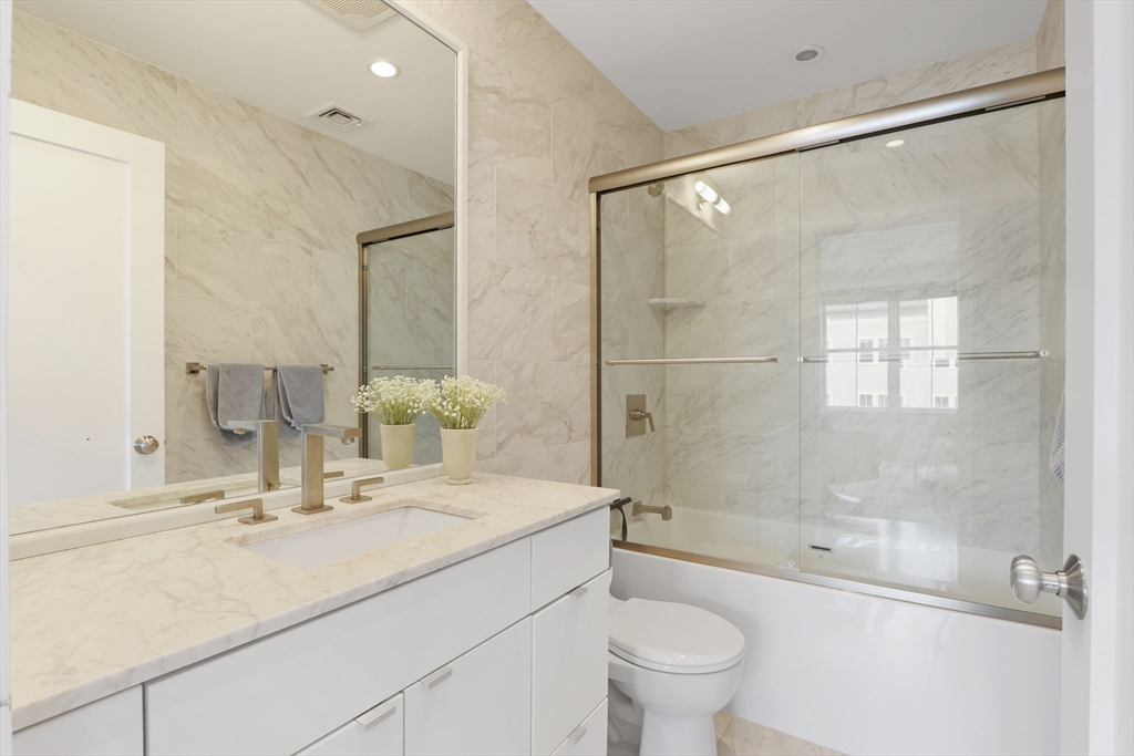 309 E Street, Unit 45 Boston, MA 02127 - Photo 18 of 33 a bathroom with a sink shower and a toilet