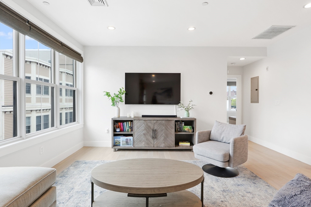 309 E Street, Unit 45 Boston, MA 02127 - Photo 2 of 33 a living room with furniture and a flat screen tv