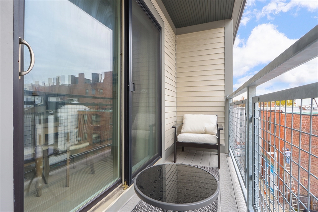 309 E Street, Unit 45 Boston, MA 02127 - Photo 21 of 33 a balcony with table and chairs