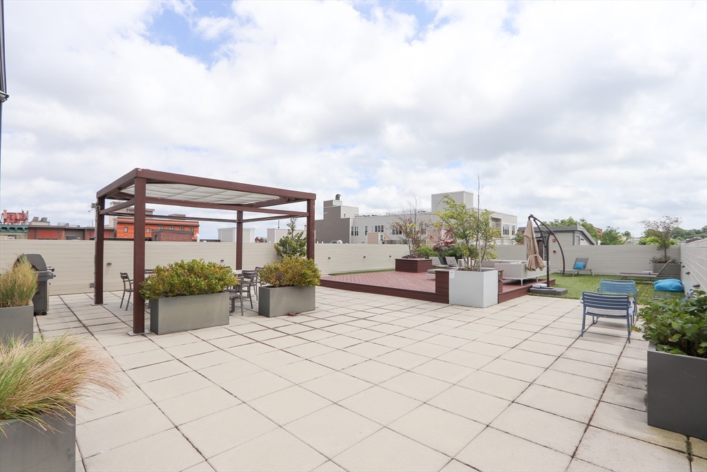 309 E Street, Unit 45 Boston, MA 02127 - Photo 24 of 33 a roof deck with table and chairs and potted plants