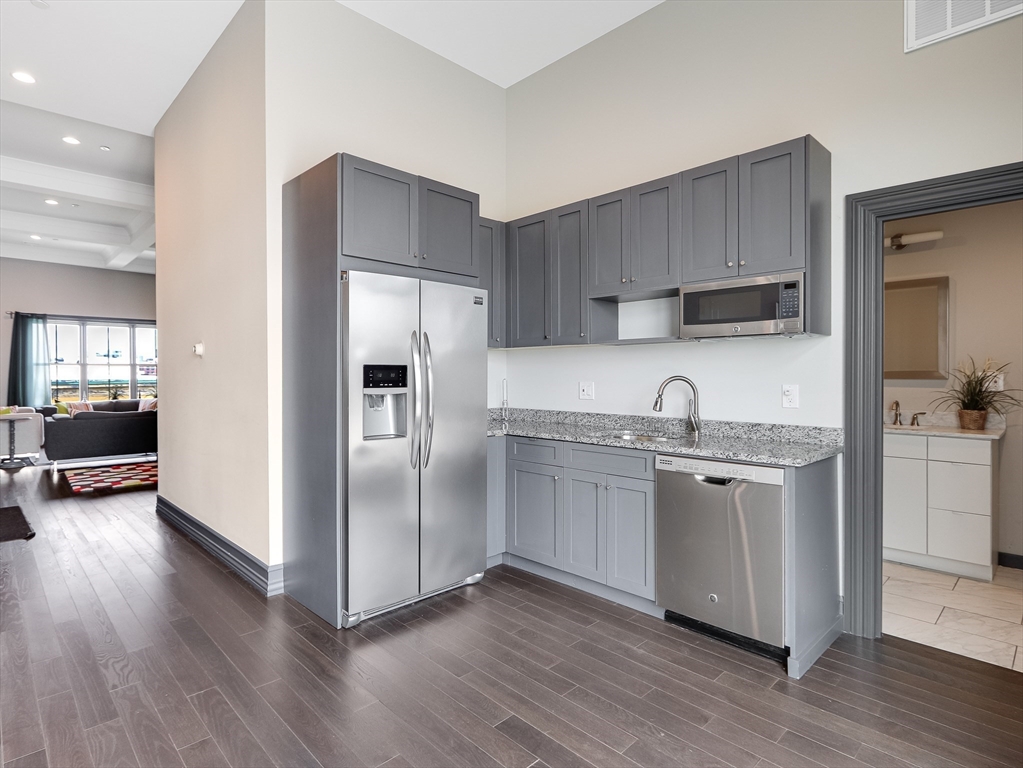 309 E Street, Unit 45 Boston, MA 02127 - Photo 31 of 33 a kitchen with granite countertop a refrigerator and a sink