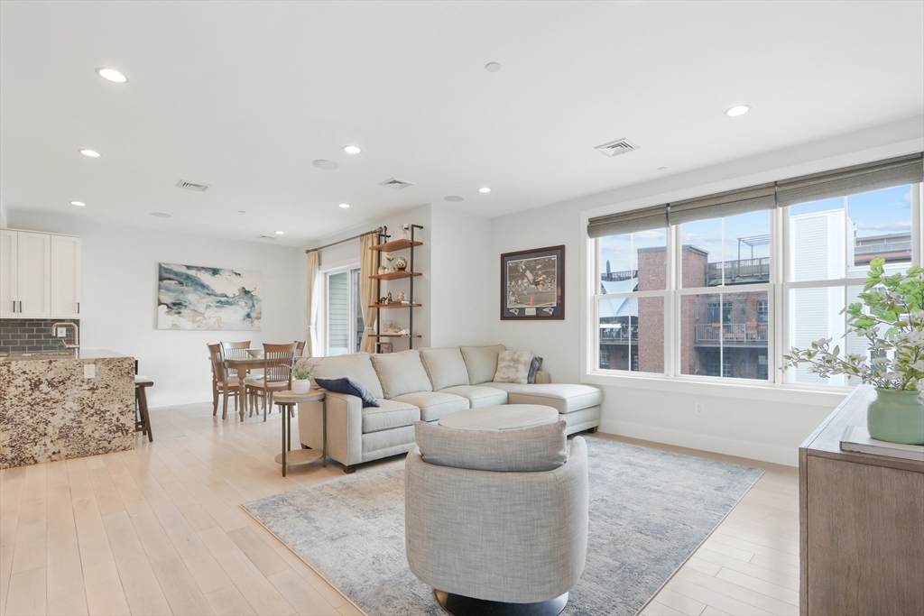 309 E Street, Unit 45 Boston, MA 02127 - Photo 4 of 33 a living room with furniture and large windows