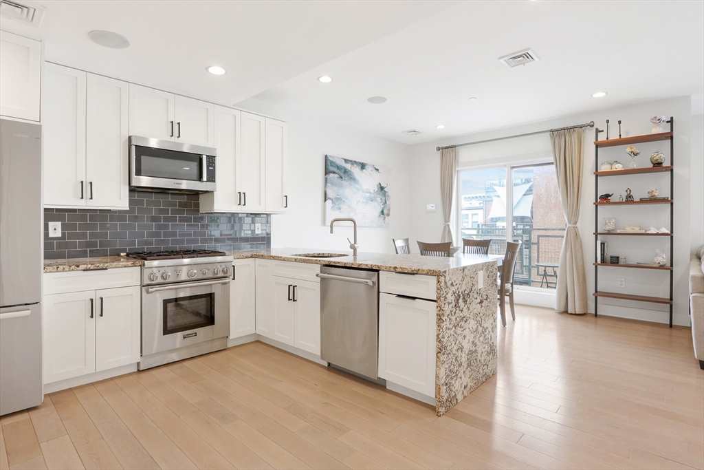 309 E Street, Unit 45 Boston, MA 02127 - Photo 6 of 33 a kitchen with cabinets appliances and a window