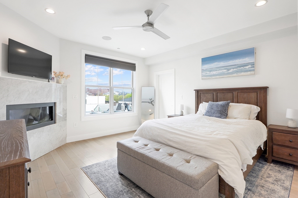 309 E Street, Unit 45 Boston, MA 02127 - Photo 10 of 33 a bedroom with a large bed and a flat screen tv