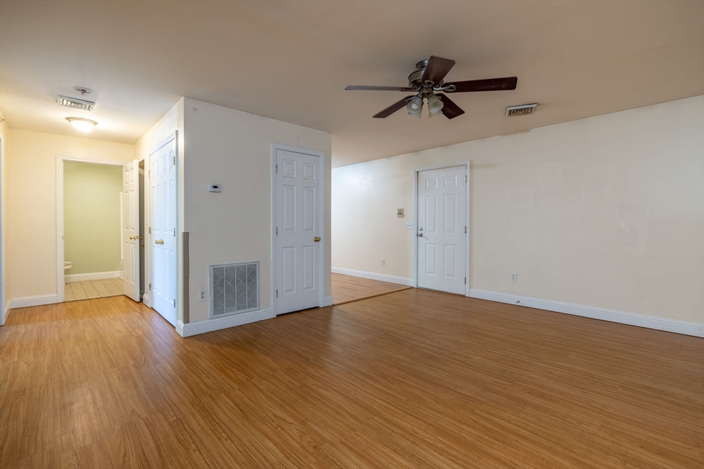 1556 North Main Street, Unit 10 Fall River, MA 02720 - Photo 11 of 30 a view of empty room with wooden floor and ceiling fan