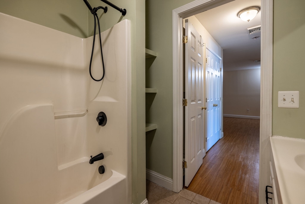 1556 North Main Street, Unit 10 Fall River, MA 02720 - Photo 13 of 30 a bathroom with a bathtub and a shower