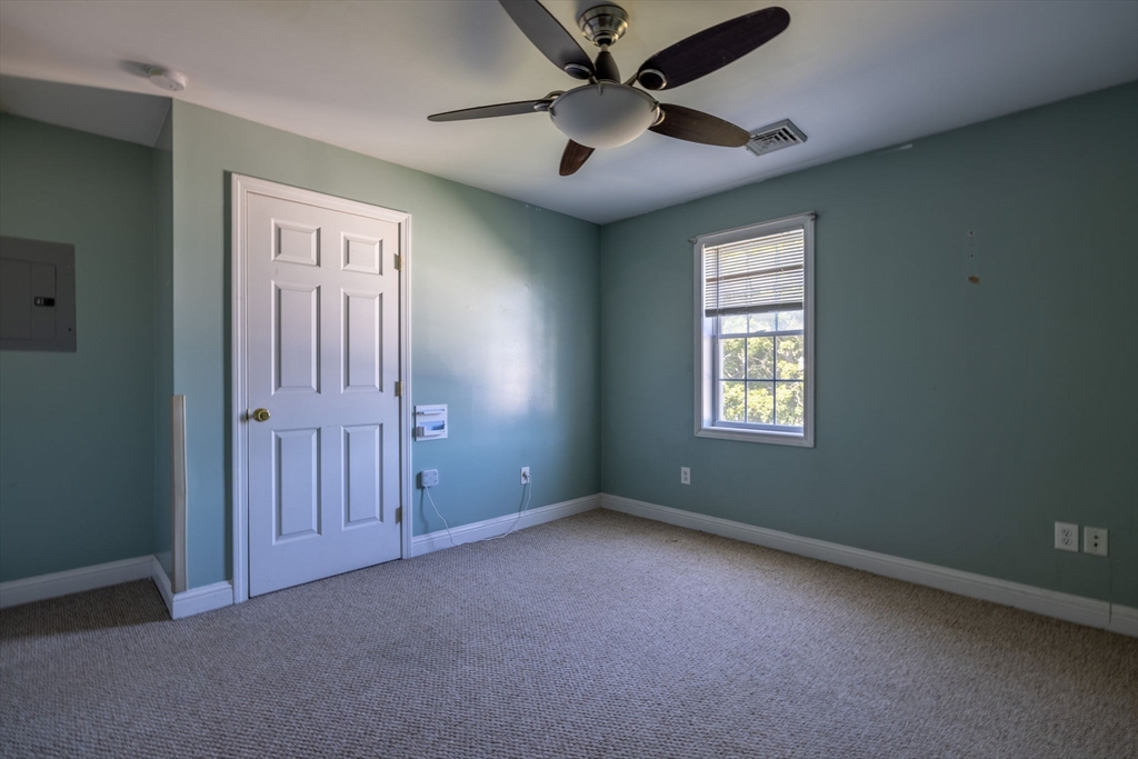 1556 North Main Street, Unit 10 Fall River, MA 02720 - Photo 15 of 30 an empty room with windows and fan