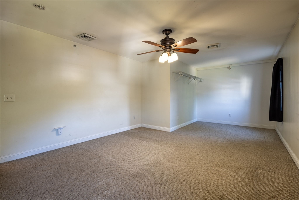 1556 North Main Street, Unit 10 Fall River, MA 02720 - Photo 17 of 30 an empty room with windows and fan