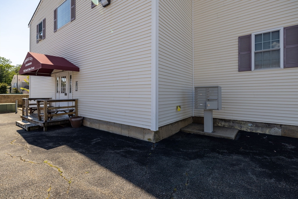 1556 North Main Street, Unit 10 Fall River, MA 02720 - Photo 2 of 30 a view of a house with a yard