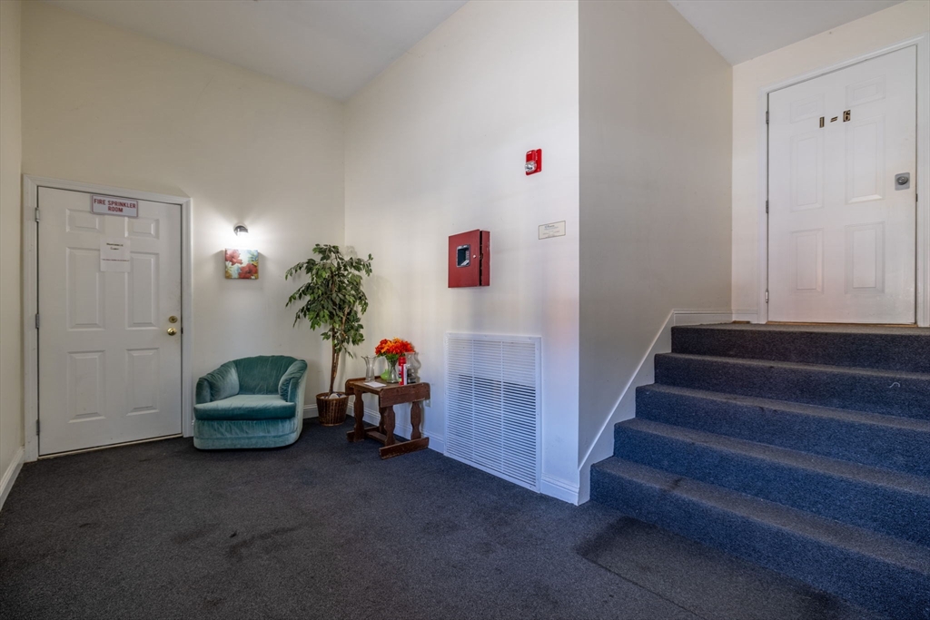 1556 North Main Street, Unit 10 Fall River, MA 02720 - Photo 22 of 30 a living room with furniture and a stairs