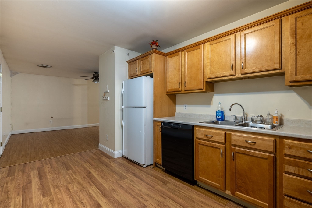 1556 North Main Street, Unit 10 Fall River, MA 02720 - Photo 9 of 30 a kitchen with wooden cabinets and refrigerator