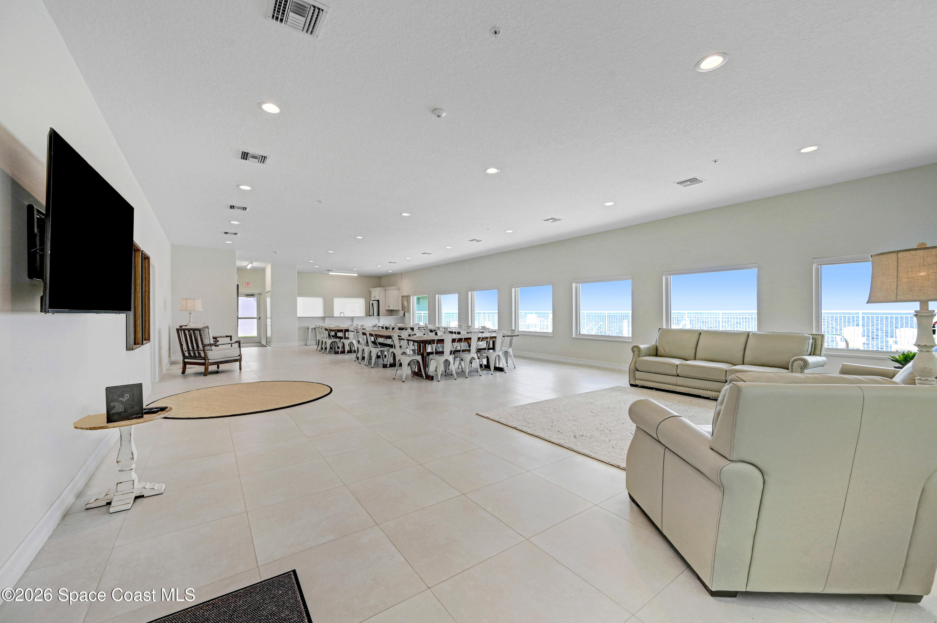 1805 Riverside Drive, Unit 304 Titusville, FL 32780 - Photo 41 of 46 a living room with furniture and a flat screen tv