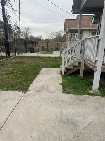 a view of a house with a yard and sitting area