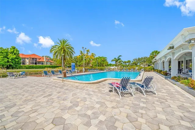 a view of a house with swimming pool and yard