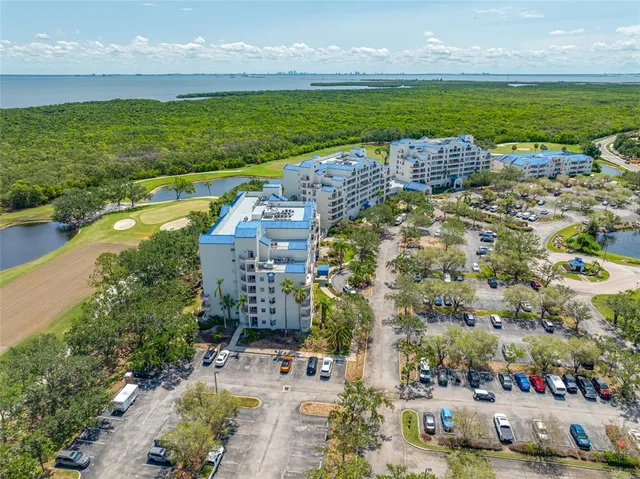a front view of a building with swimming pool and outdoor seating