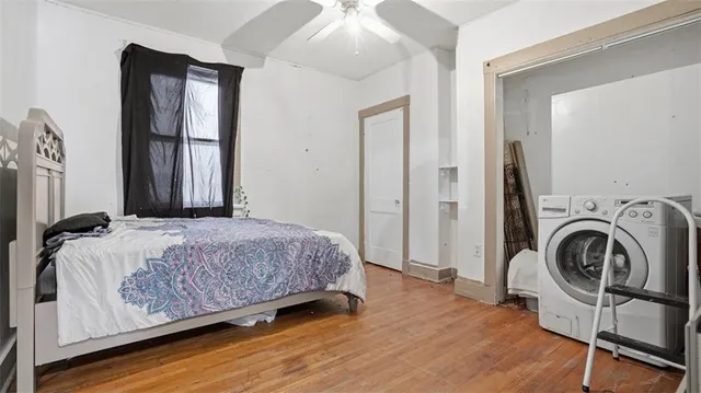 a bedroom with a bed a mirror and furniture