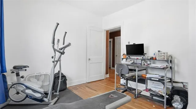 a view of a workspace with furniture and a flat screen tv