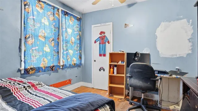 a bed room with a bed and a chair