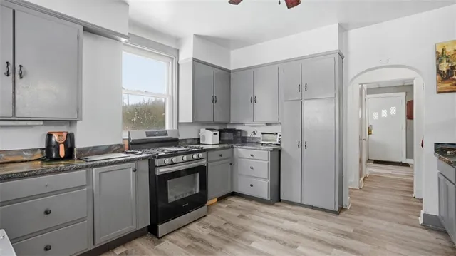 a kitchen with a stove a sink and a refrigerator