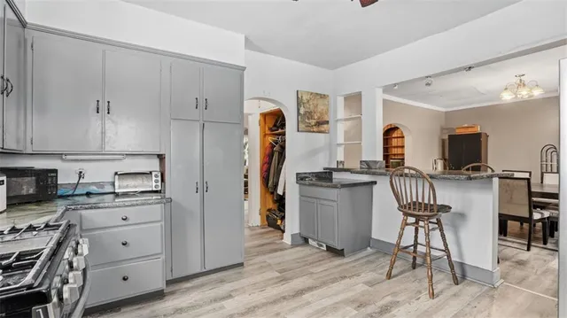 a kitchen with a refrigerator a stove and a cabinets