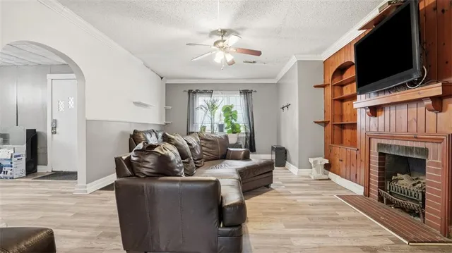 a living room with furniture fireplace and flat screen tv