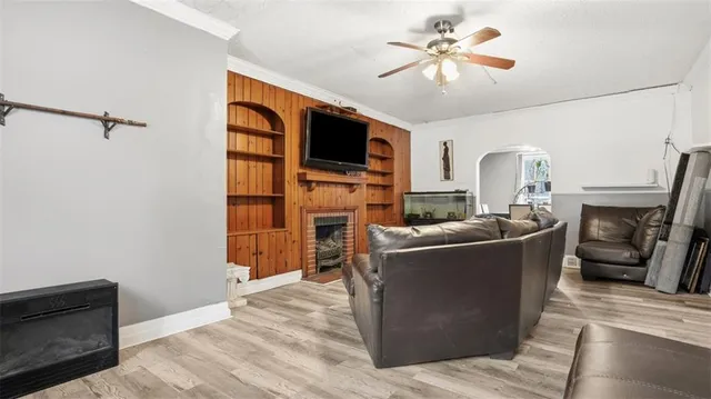 a living room with furniture a flat screen tv and a fireplace