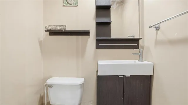 a bathroom with a sink a toilet and mirror