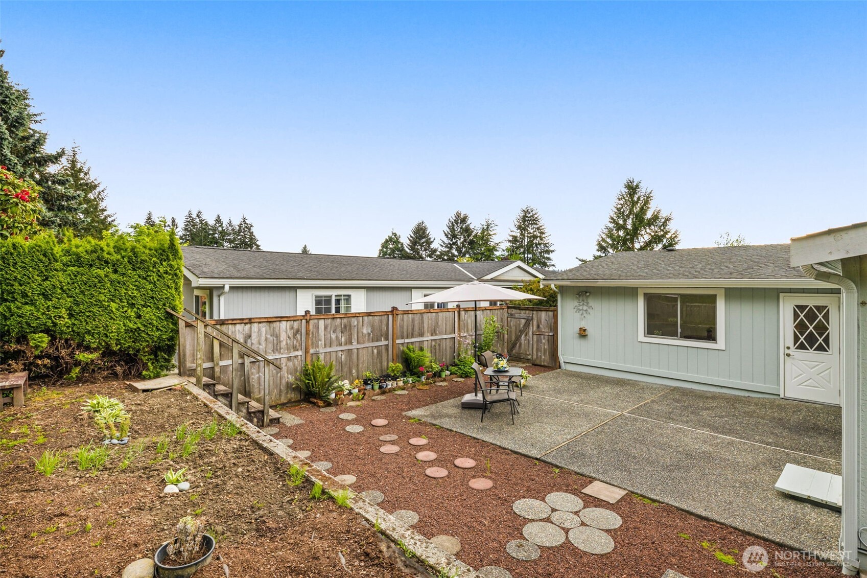 23807 7th Place West Bothell, WA 98021 - Photo 22 of 26 a backyard of a house with table and chairs