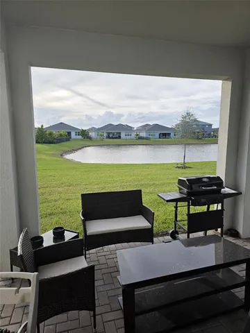 a view of a terrace with couches and pool