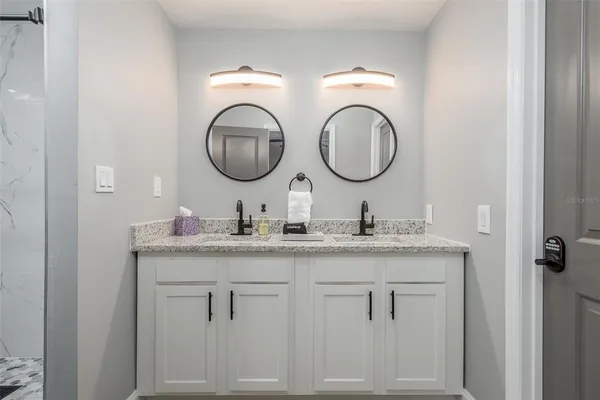 a bathroom with 2 sink and a mirror