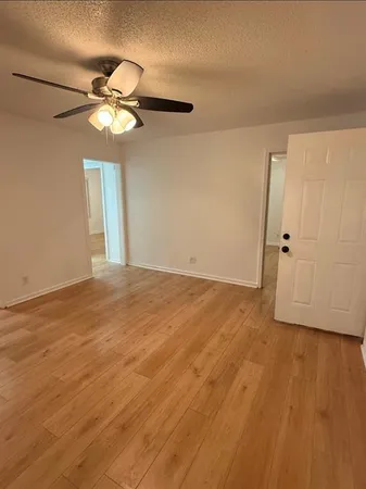 a kitchen with granite countertop white cabinets and a stove top oven