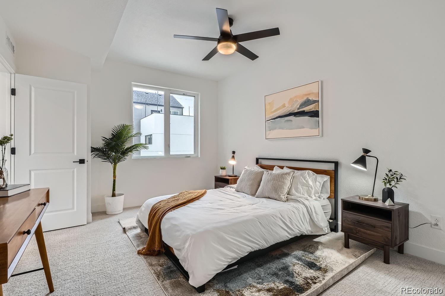 10157 West 38th Avenue Wheat Ridge, CO 80033 - Photo 11 of 50 a bedroom with bed and a chandelier