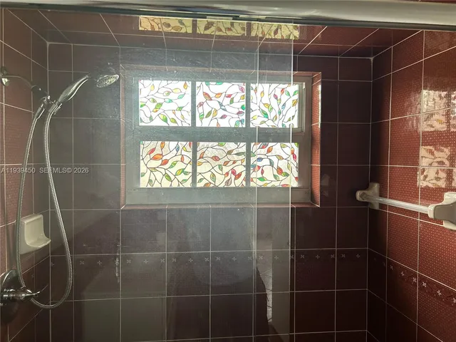 a bathroom with a glass shower door and sink